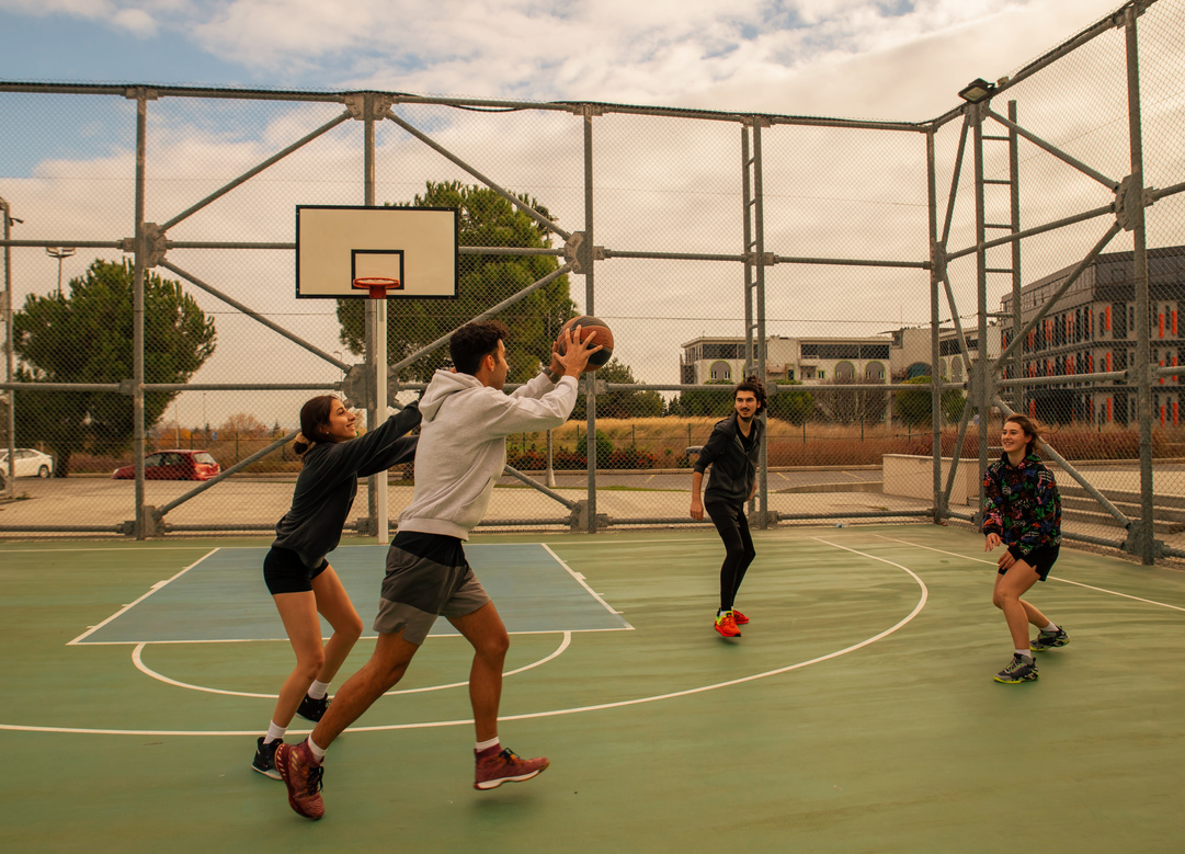 Friends Playing Basketball at Outdoor Court